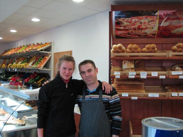 Remzi from Kosovo with Lidiya in his fruit store and bakery
